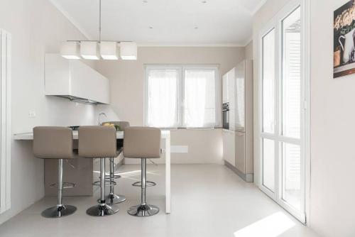 a white kitchen with a table and some chairs at Villa Liliana - Large Private House in Vicopisano in Vicopisano