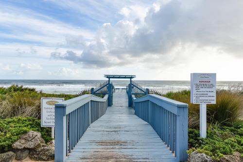 a blue boardwalk leading down to the beach at 561 Cinnamon Beach in Palm Coast