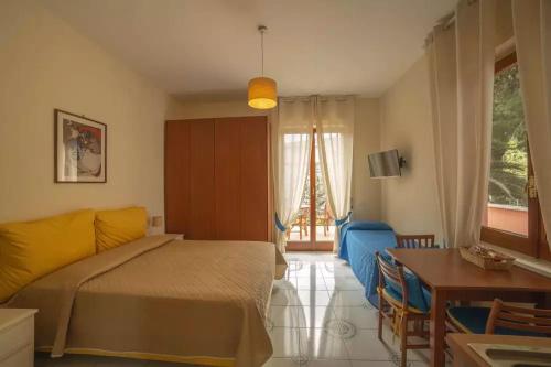 a bedroom with a bed and a table and a room at Villa Rosa Sorrento in Sorrento