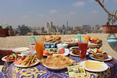 a table with plates of food and drinks on it at Osiris Hotel Cairo in Cairo