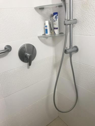 a shower with a hose in a bathroom at Schöne zimmer in der city tel-aviv in Karkom