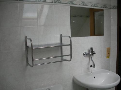 a bathroom with a sink and a mirror on the wall at Penzion u Krumlova in Srnín