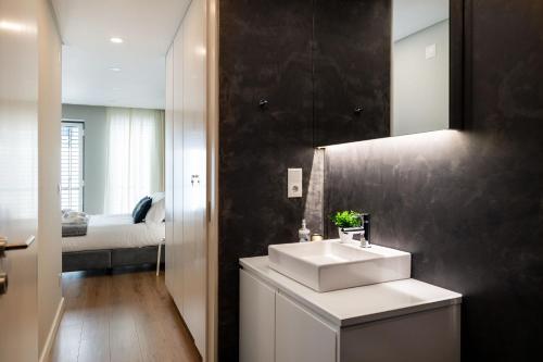 En eller flere senge i et værelse på Alcântara Factory II