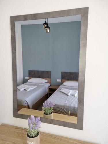 a mirror in a room with two beds at Chriselia House in Nea Roda