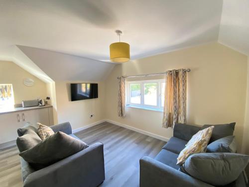 a living room with two couches and a window at Hodge Bower Holidays, Ironbridge - Blades in Ironbridge