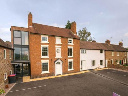 a brick building with a parking lot in front of it at Hodge Bower Holidays, Ironbridge - Blades in Ironbridge