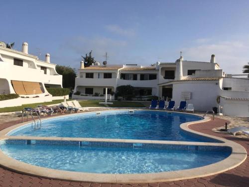 a large swimming pool in front of a house at ML Carvoeiro Mar Apartment in Carvoeiro