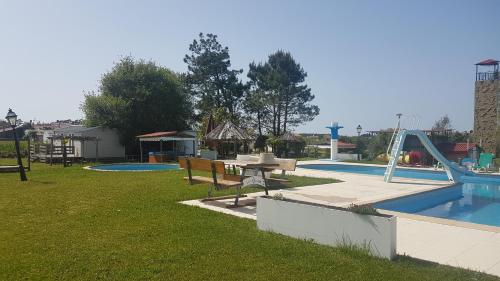 a park with a pool with a picnic table and a playground at A casinha da aguieira na Lands Hause L6 in Burinhosa