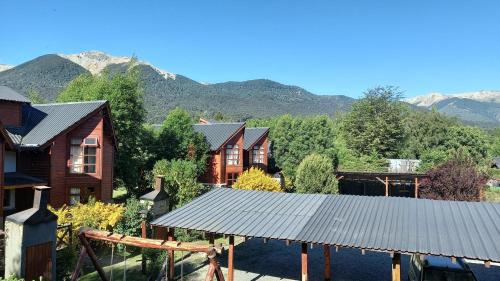 a group of houses with mountains in the background at Bellavista in Villa La Angostura