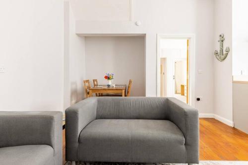 a living room with a couch and a table at The Hideaway, Family apartment close to the beach. in Paignton
