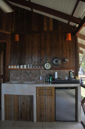 a kitchen with wooden walls and a counter top at Las Brisas del Sur in Ojochal