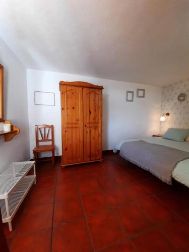 a bedroom with a bed and a wooden cabinet at Casita Miramar in El Paso