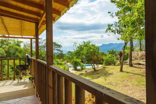 a view from the deck of a resort with a pool at Cabaña en El Guadual in Santandercito