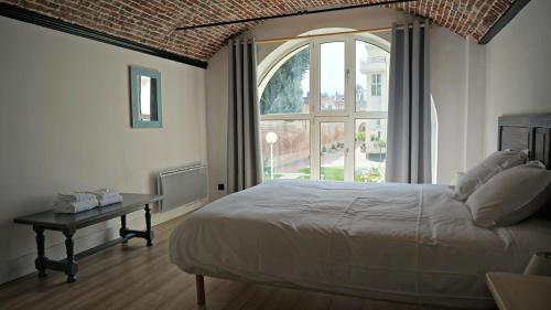 une chambre avec un lit et une grande fenêtre dans l'établissement Little Suite - Coline, à Lille