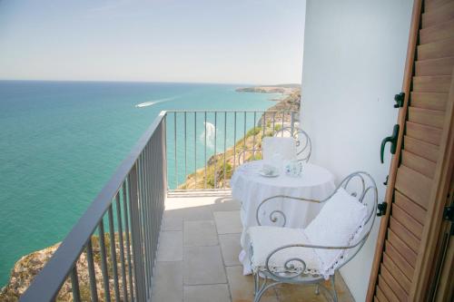a table and chairs on a balcony overlooking the ocean at Gli Orti Di Malva B&B in Peschici