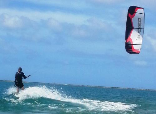 a man kite surfing in the ocean on the water at Fiji Lodge Vosa Ni Ua in Savusavu