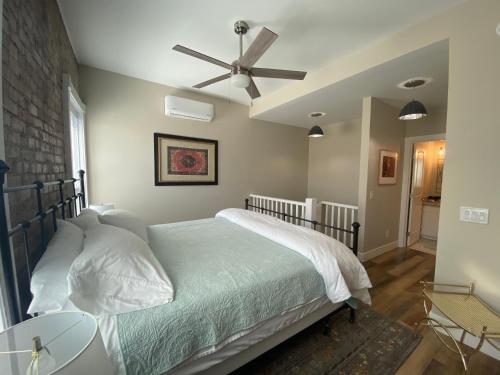 a bedroom with a bed with a ceiling fan at Bisbee Brownstone Suites in Bisbee