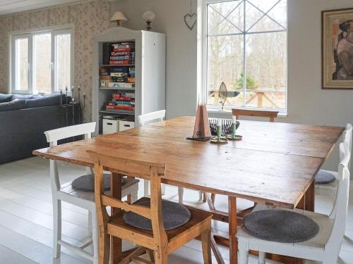 a dining room with a wooden table and chairs at 6 person holiday home in RONNEBY-By Traum in Ronneby