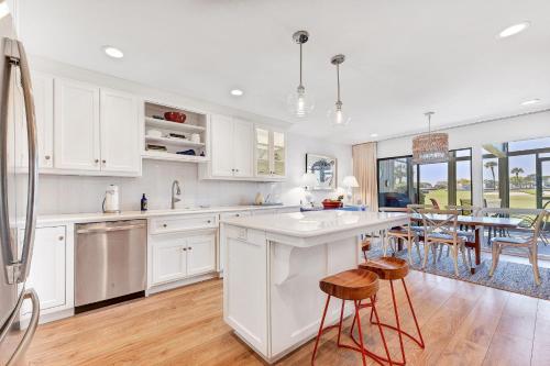 a kitchen with white cabinets and a table with chairs at Ponte Vedra Deer Run 9770 in Ponte Vedra