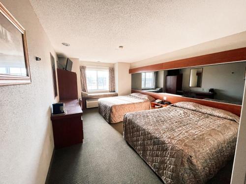 a hotel room with two beds and a window at WELCOME INN & SUITES in Tunica Resorts