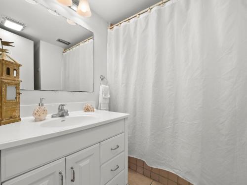a bathroom with a sink and a shower curtain at Surf Villa 626, 1 Bedroom, Beach Front, WiFi, Sleeps 4 in Ponte Vedra