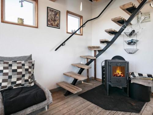 a fireplace in a living room with a stove at 2 person holiday home in Brovst-By Traum in Brovst