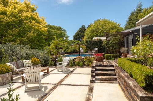 un jardin avec une terrasse et une piscine dans l'établissement Bradleys Garden Bed and Breakfast, à Taumarunui