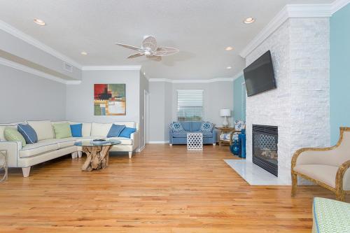 a living room with a couch and a fireplace at High Tide in Saint Augustine
