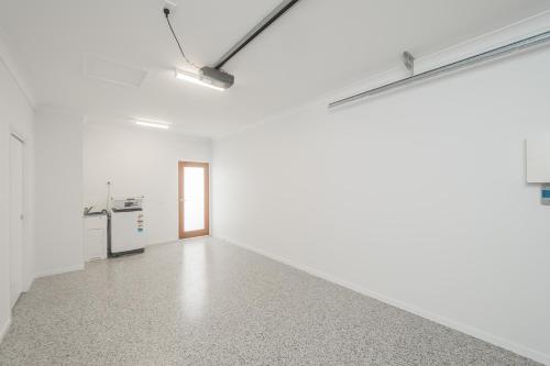 an empty room with white walls and a hallway at Jardine Court Appartments in Rockhampton