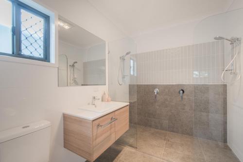 a bathroom with a sink and a shower and a toilet at Jardine Court Appartments in Rockhampton