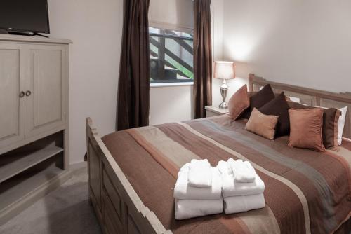 a bedroom with a large bed with two white towels at Robins Nest in Ruidoso