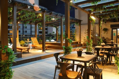 an outdoor patio with tables and chairs and lights at Gamalan Spring Hotel in Jiaoxi