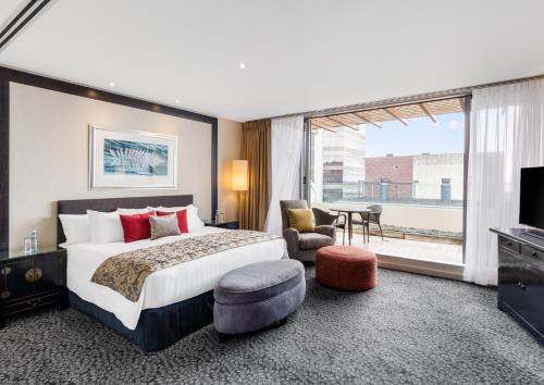a hotel room with a bed and a large window at Crowne Plaza Auckland, an IHG Hotel in Auckland