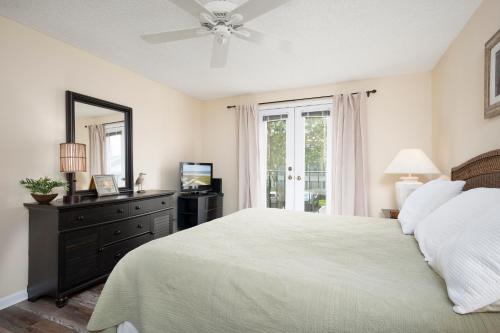 a bedroom with a bed and a dresser with a mirror at Ponte Vedra Colony Circle 75, 2 Bedrooms, Sleeps 4 in Ponte Vedra