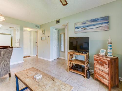 a living room with a tv and a table at Ocean Village Club N16 in Saint Augustine