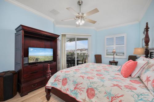 a bedroom with a bed and a flat screen tv at 442 Cinnamon Beach, 3 Bedroom, Sleeps 8, Ocean View, 2 Pools, Pet Friendly in Palm Coast