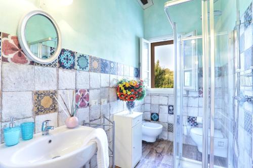 a bathroom with a sink and a mirror at Wonderful Family Suite in Tuscany near Pisa and Florence - Two Bedrooms 4 pl in Molino del Roglio