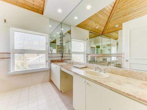 a bathroom with a sink and a large mirror at Ocean Pearl, 4 Bedrooms, Sleeps 13, Private Pool, Ocean Front in Saint Augustine