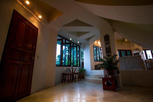 a hallway with a door and windows in a building at Monkey Flower Villas in Koh Tao