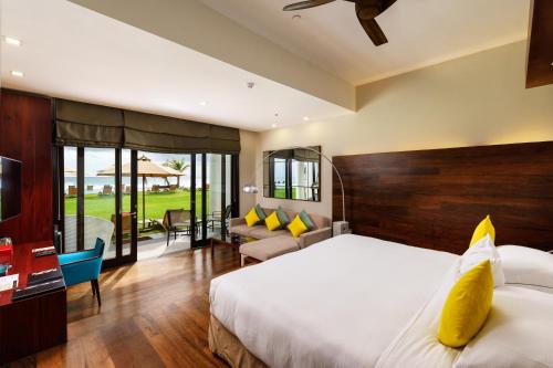 a bedroom with a bed and a living room at The Fortress Resort & Spa in Koggala