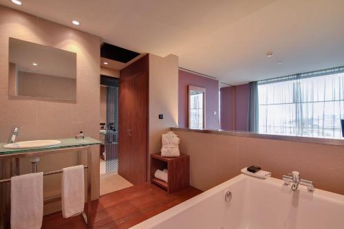 a large bathroom with a tub and a sink at Hotel Badalona Tower in Badalona