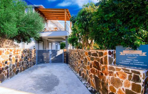 une maison avec un mur en pierre et un escalier dans l'établissement Bitsakis Family - Paleochora Luxury Villa, à Paleóchora