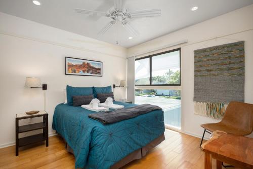 a bedroom with a blue bed and a window at Deer Run 9767, 3BRs, Pool Access, Near Beach, Sleeps 8 in Ponte Vedra