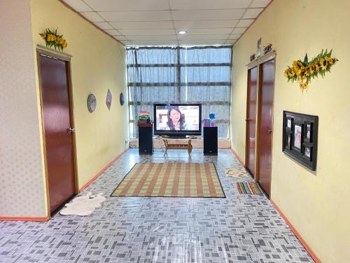 a hallway with a television in a room at VIE HOMESTAY TAWAU in Tawau