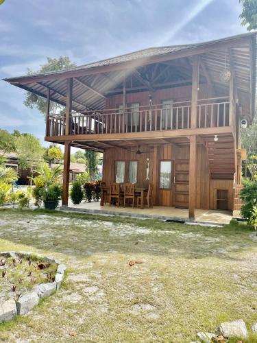 a large wooden house with a large deck at Leebong Island Resort in Leebong