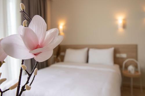 a white flower sitting on top of a bed at Zefyros Sea View Hotel in Platamonas