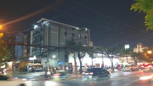 a busy city street at night with cars at W71 in Bangkok