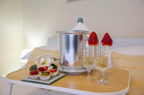 a table with two wine glasses and cupcakes on it at Les Suites di Sara 3 and 5 - Happy Rentals in Riva del Garda