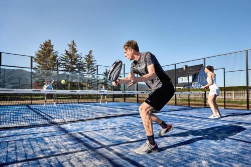 a group of people playing tennis on a tennis court at Landhaus Wilhelmer in Fohnsdorf