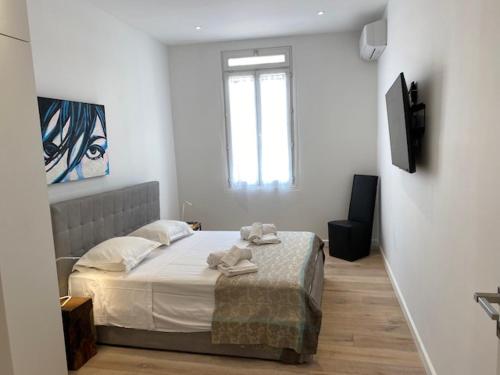 une chambre avec un lit avec des serviettes dessus dans l'établissement M.M.R. Au cœur de la vie cannoise, à Cannes